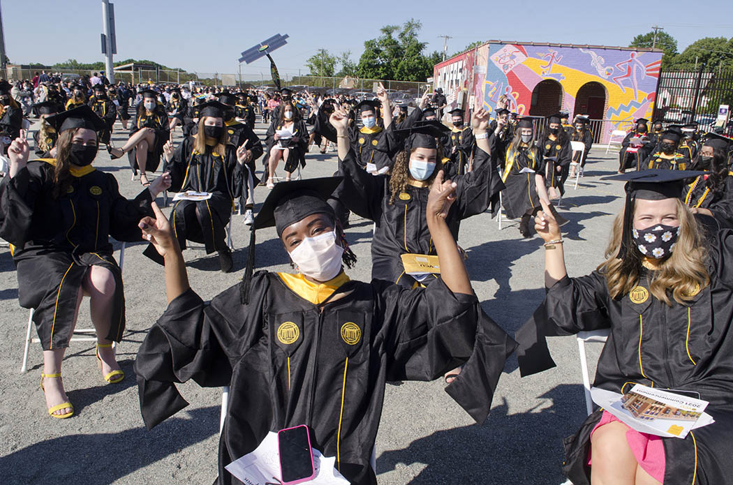 A full house of M-S-W graduates, all masked, celebrate while sitting in the outdoor ceremony at City Stadium.