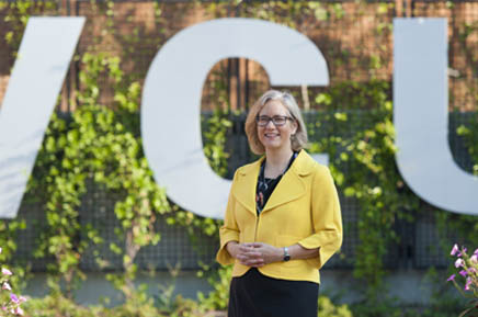 Beth Angell, Ph.D., dean and professor, at the V-C-U letters near the Compass, Monroe Park Campus