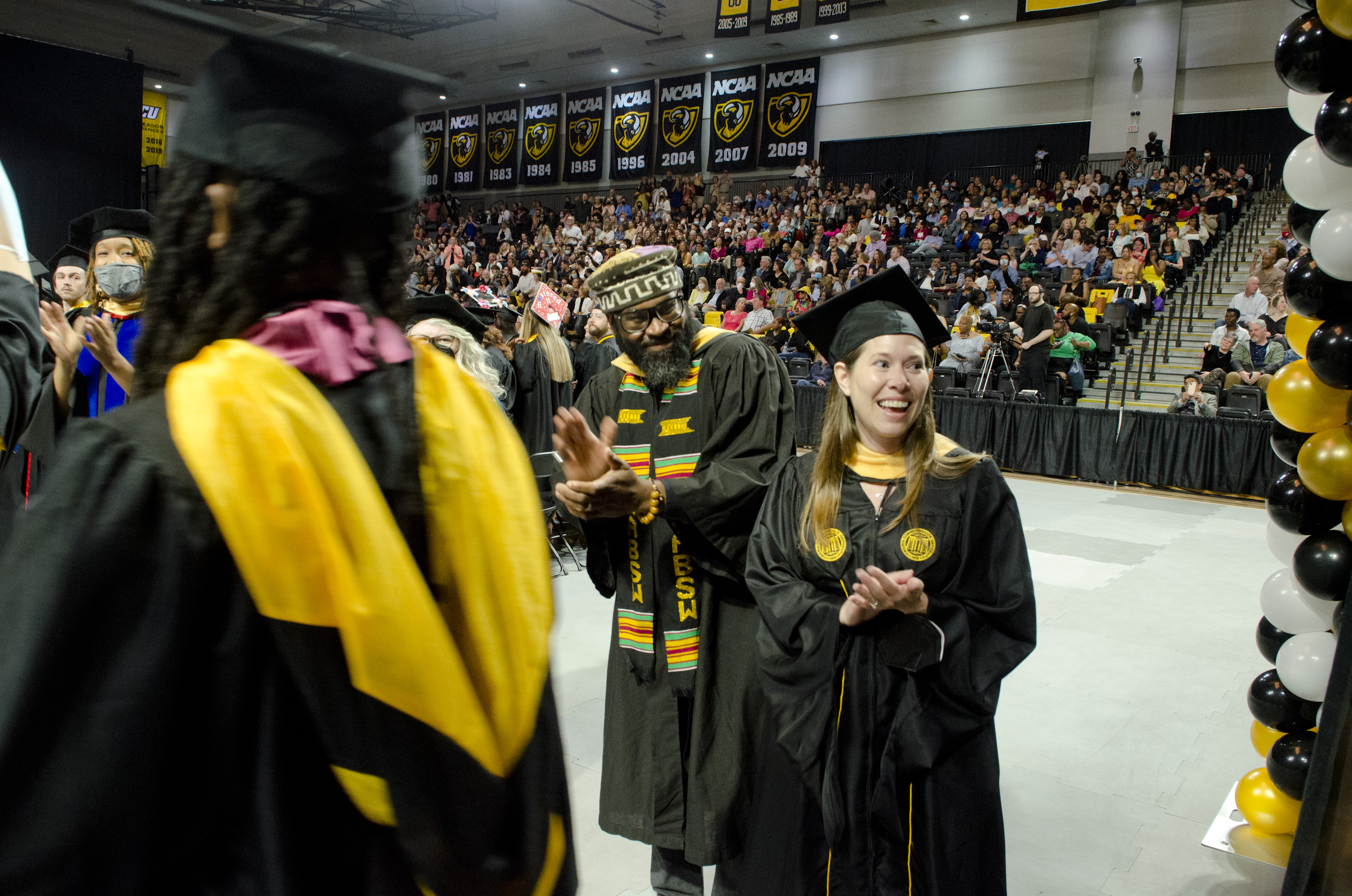 VCU faculty members Daryl Fraser and Allison Ryals applaud during the May 2022 Commencement ceremony.