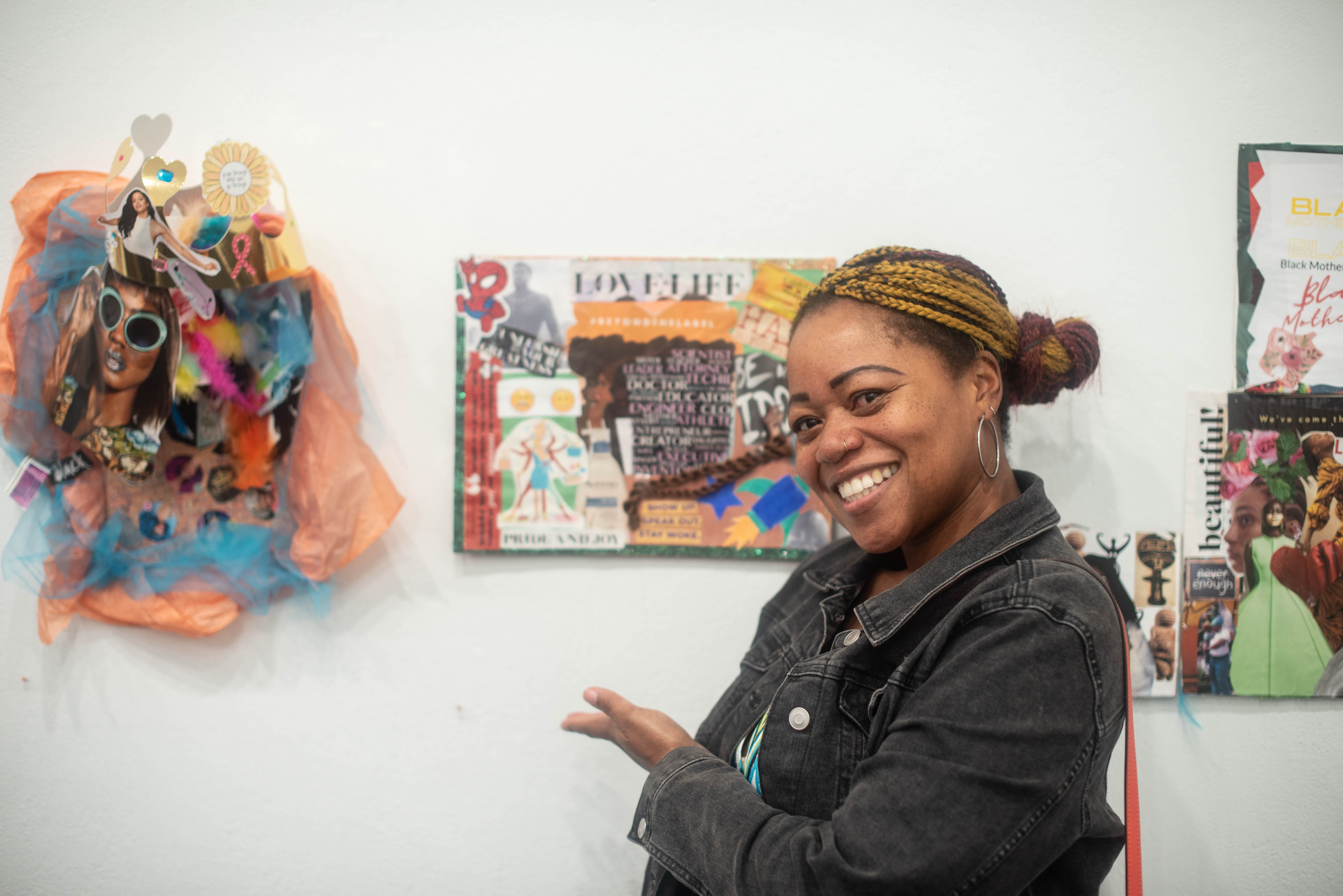 A project participant/artist shows off their work at the And, Ain't I a Mother art exhibition.