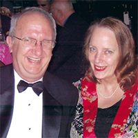 Chuck Cartledge in a tuxedo and Mary Carledge in a multicolored jacket over a black top