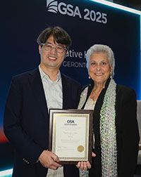 Kyeongmo Kim holding an awards plaque, with background banner reading GSA 2025.